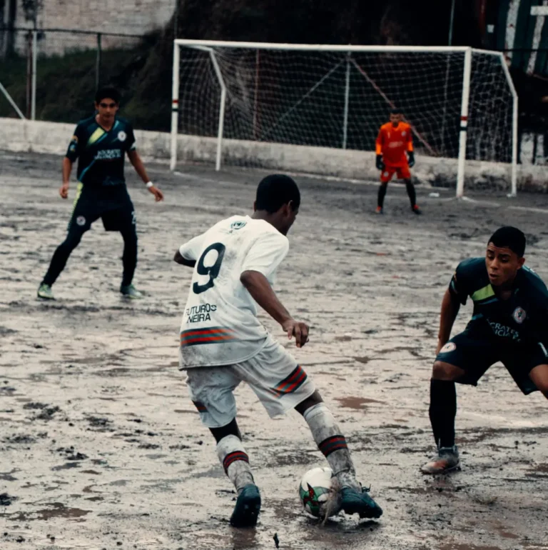 Boys Playing Soccer in the Rain